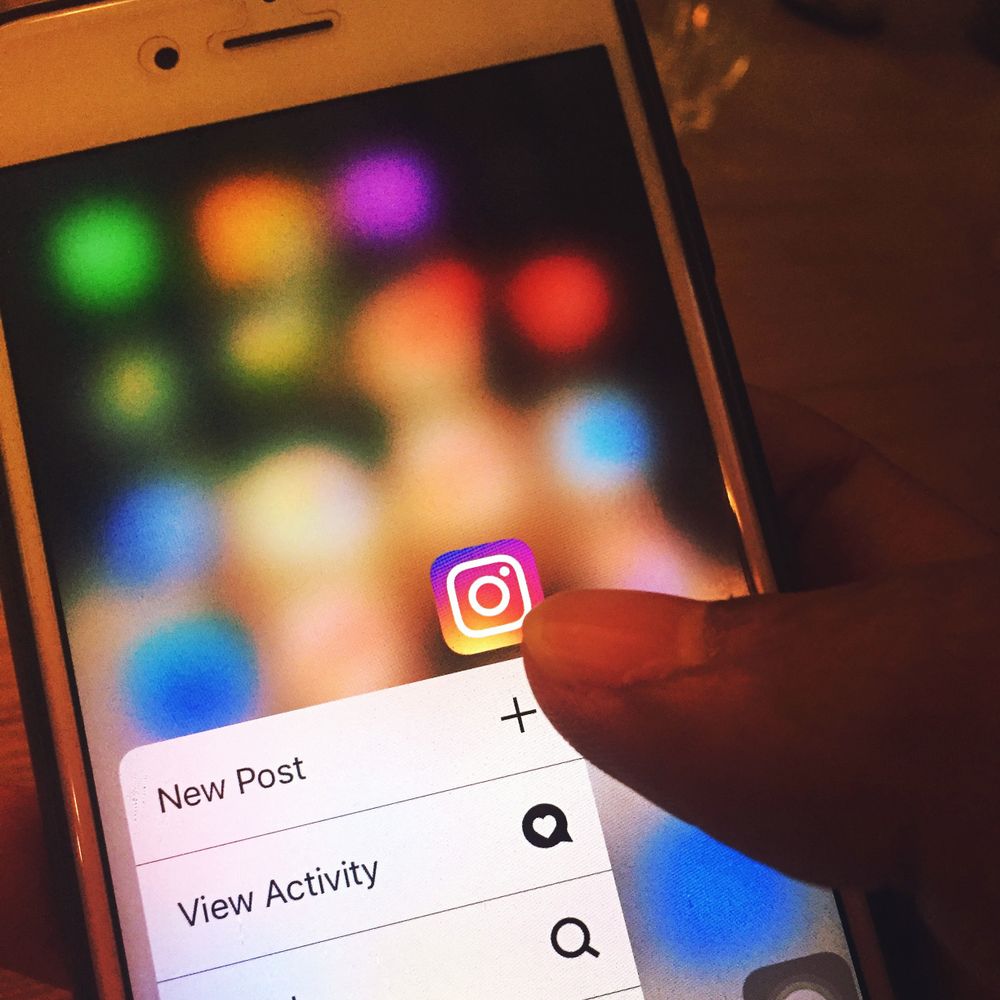 Finger navigerar i Instagram-appen på en mobilskärm